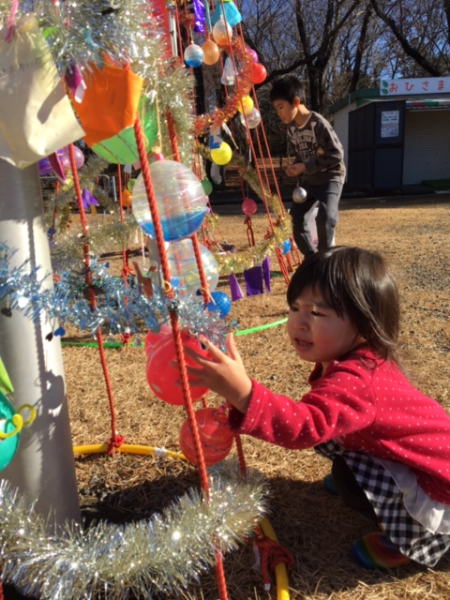 上から飾り付けられたヨーヨーを子供たちが触っている写真