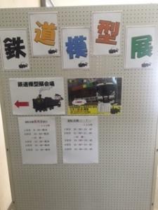 有孔ボードに鉄道模型展の案内の用紙が貼り付けられた写真