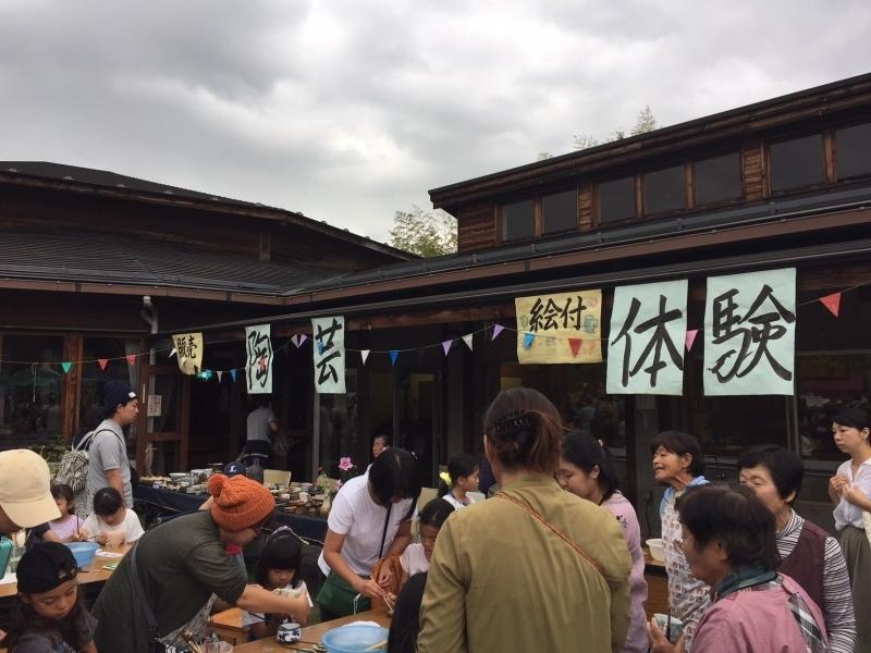 曇り空の下で陶芸体験をしている参加者達の写真