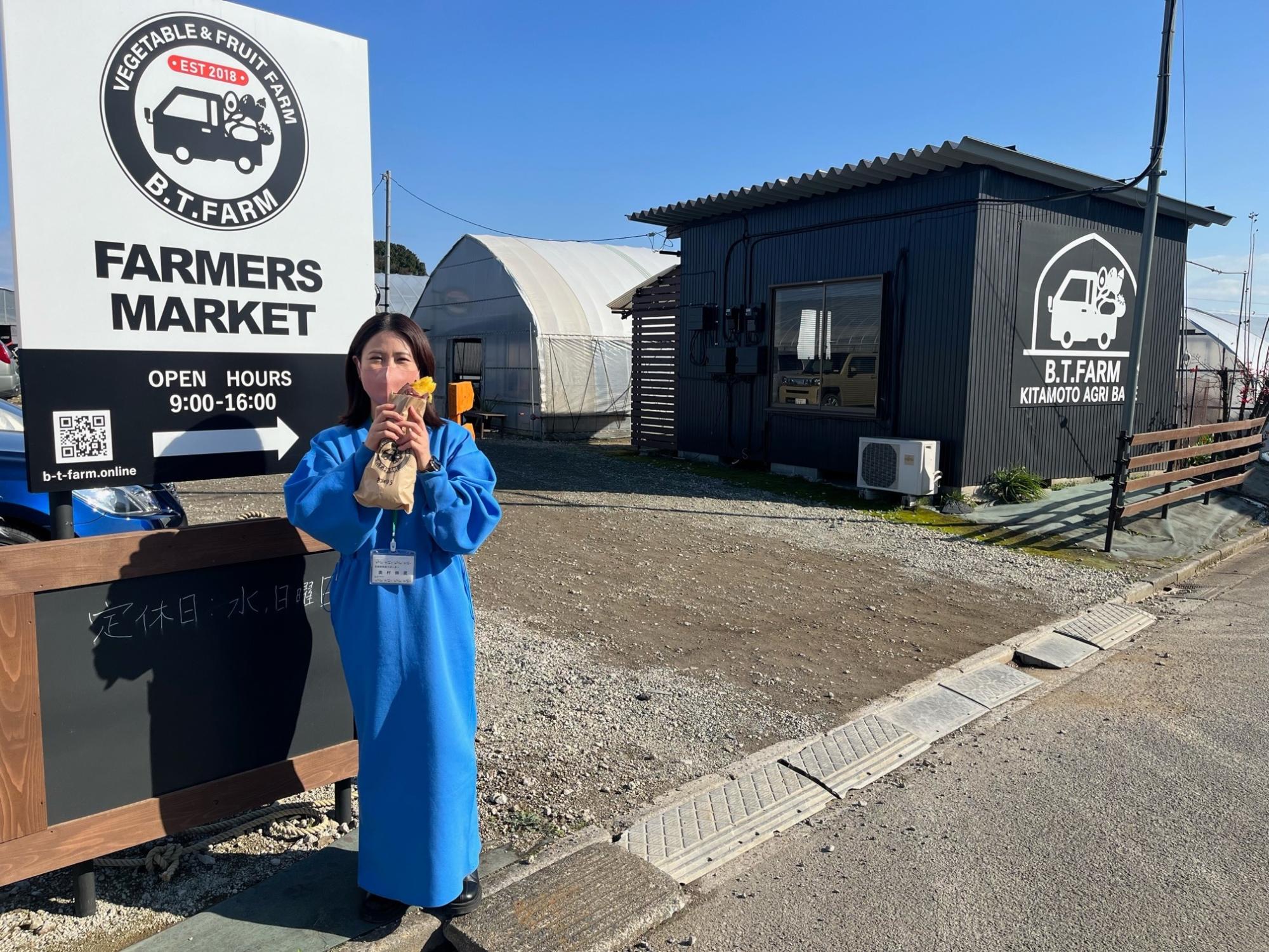 B.T.FARMの看板下に立つ奥村さん