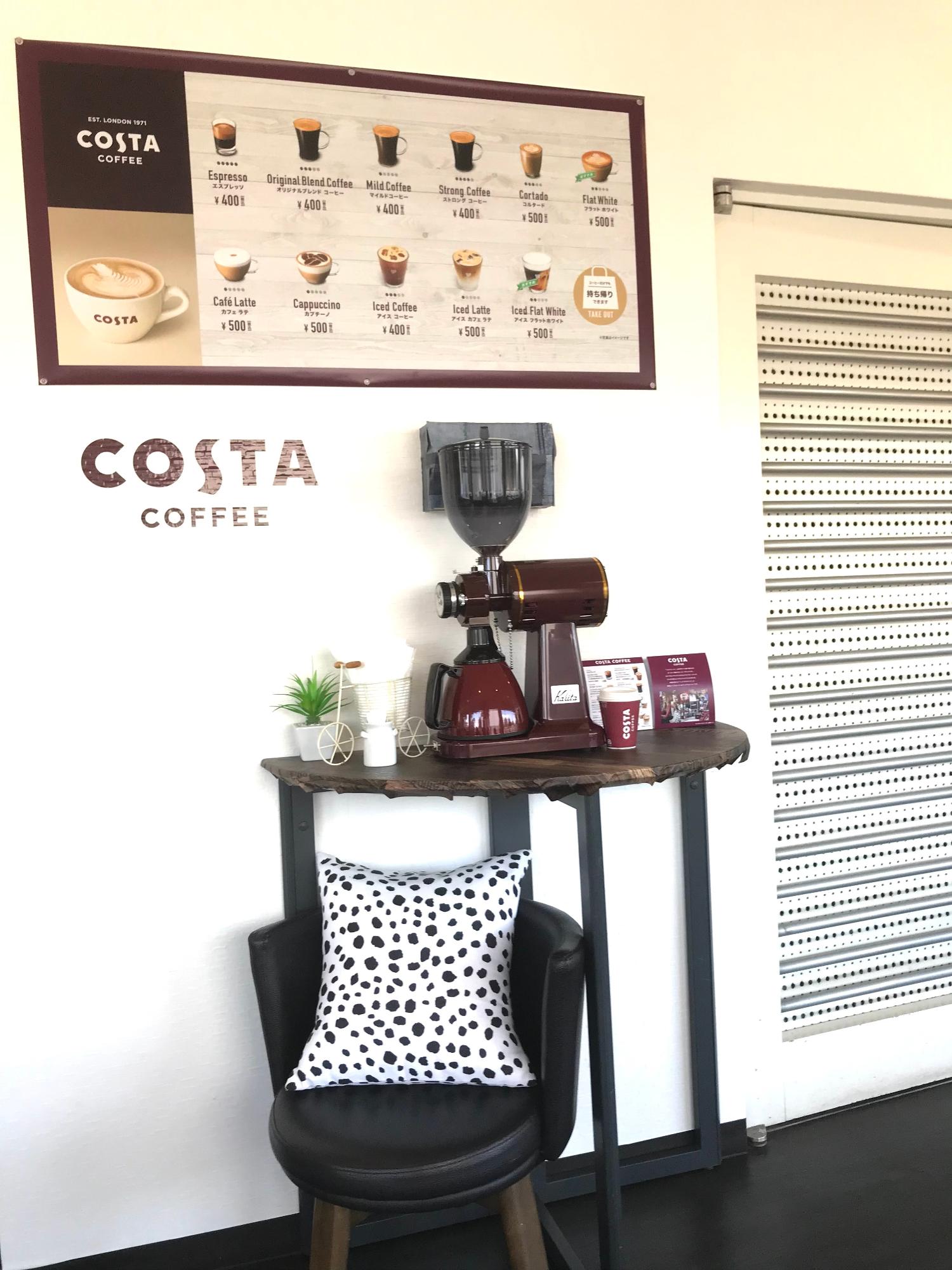 COSTAコーヒーのメニュー、コーヒーミル、丸椅子、クッションがディスプレイされた店内